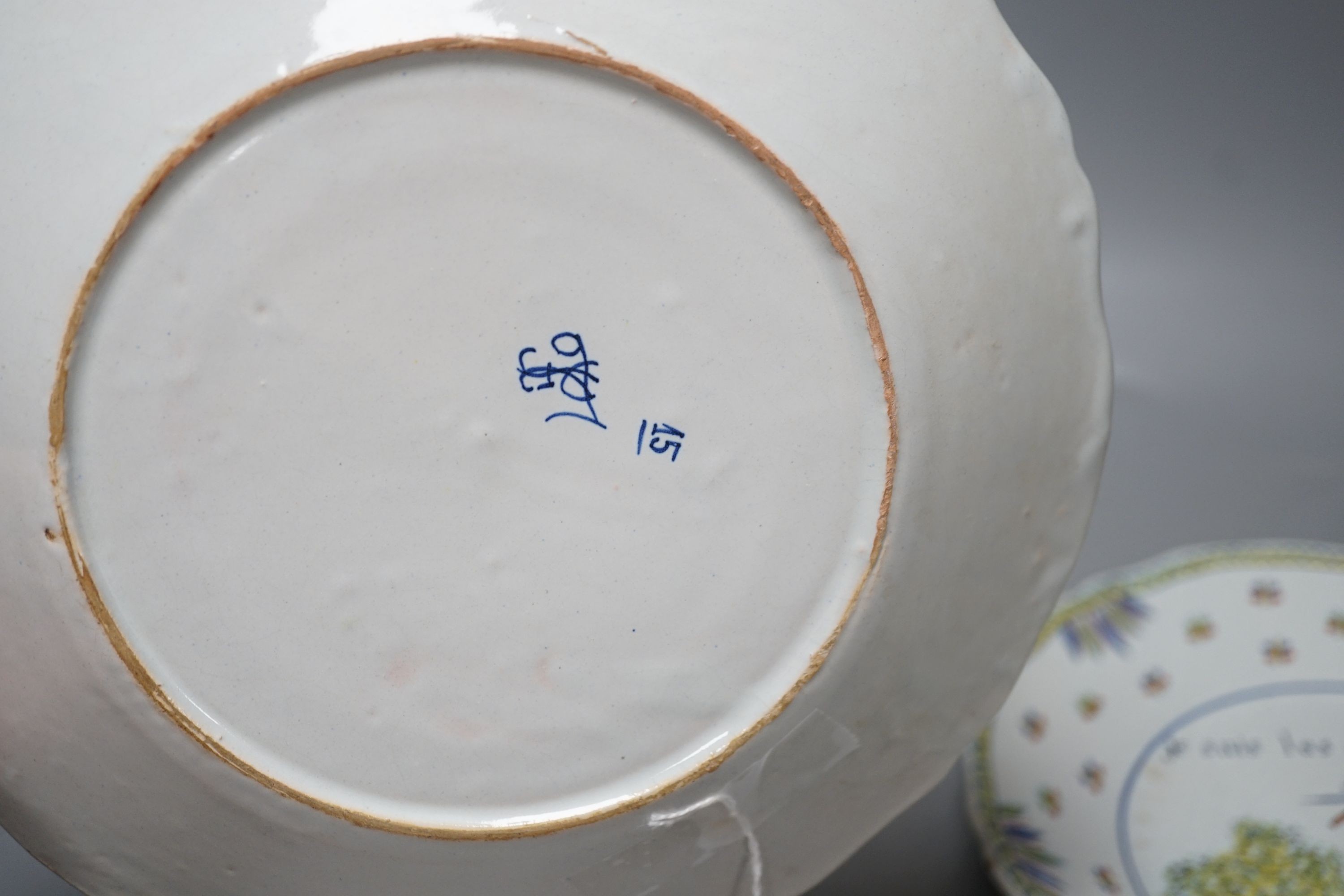 A pair of French faience plates - ‘la nation’, 1790, and ‘je suis las de les Porter’, 1791 - 24cm diameter